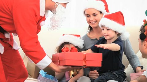 Santa Claus offering a gift to a little boy Stock Video