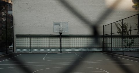 HANDHELD View of an outdoor public basketball court in New York, USA. No people. 4K RAW graded footage