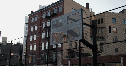 HANDHELD View of an outdoor public basketball court in New York, USA. No people. 4K RAW graded footage