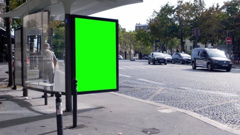 Green screen advert, bilboard on the side of a bus stop in the city center of Paris