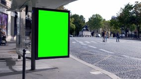 Green screen ad, bus stop advert in a street of a big town during a sunny afternoon