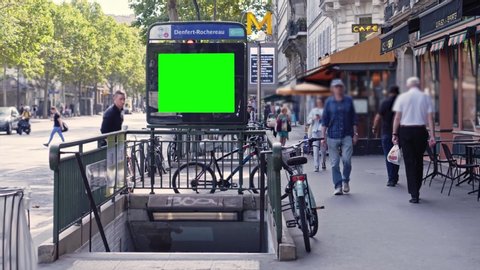 green screen, advertising billboard at the entrance of a subway station in Paris during a busy and sunny day