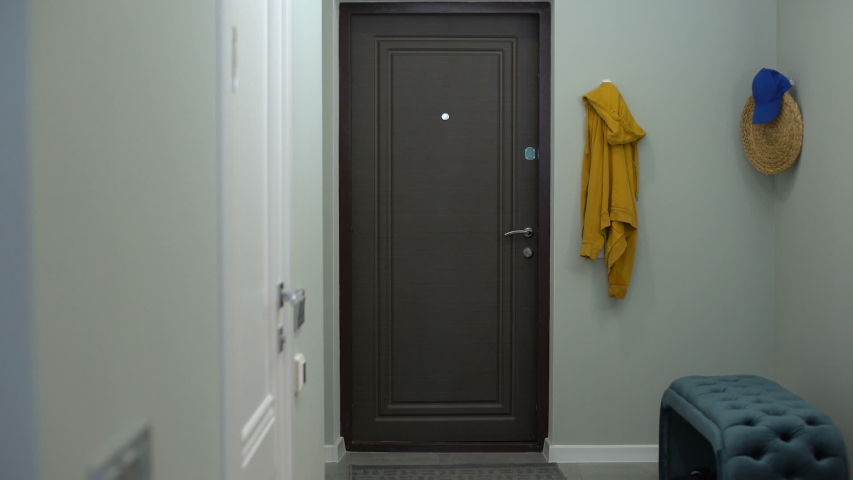 Happy girl opening door and entering apartment, just bought property, sweet home