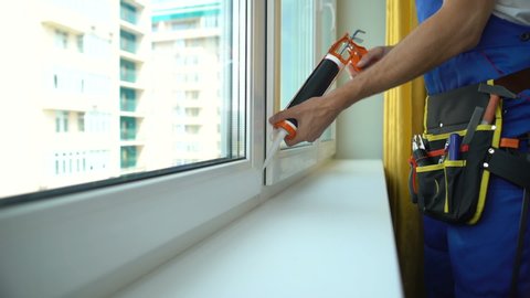 Foreman repairing window sealing frame to provide sound insulation, installation