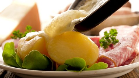 close up on cheese fondue melting on potato