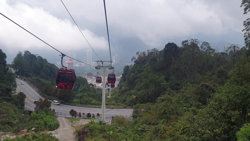 Hyperlapse Awana Skyway in Malaysia. cable car. asian. southeast asia. red cable car, green leaf. mouintain.