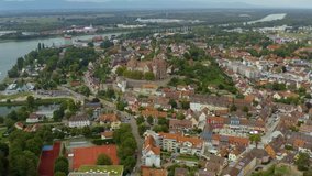Aerial view of the city Braisach am Kaiserstuhl in Germany on a late sunny day in summer. Very wide view with slow pan to the right.
