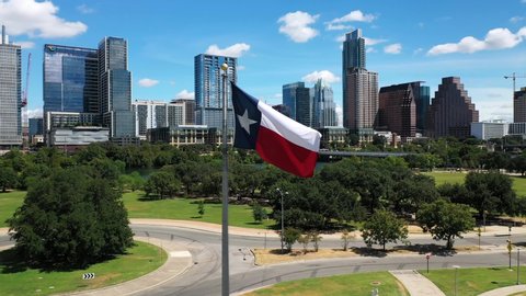 4K Aerial Texas Flag Blowing in the Wind Austin Skyline