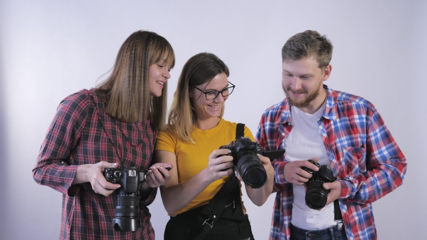 photography training, young professionals have fun studying digital cameras in photo studios during the workshop