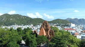 Aerial video footage of popular tourist destination of Nha Trang on the South Central Coast of Vietnam featuring the Cham towers of po nagar, and views to urban and mountain areas in bright sun
