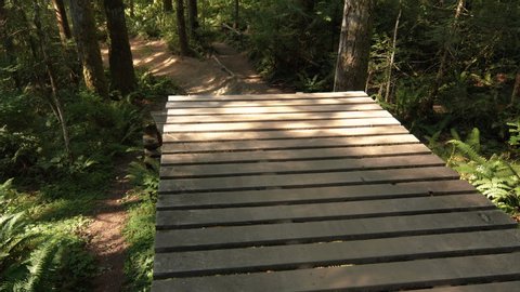 Top Angle of Man Spreading Legs for No Foot Mountain Bike Air Off Wood Jump