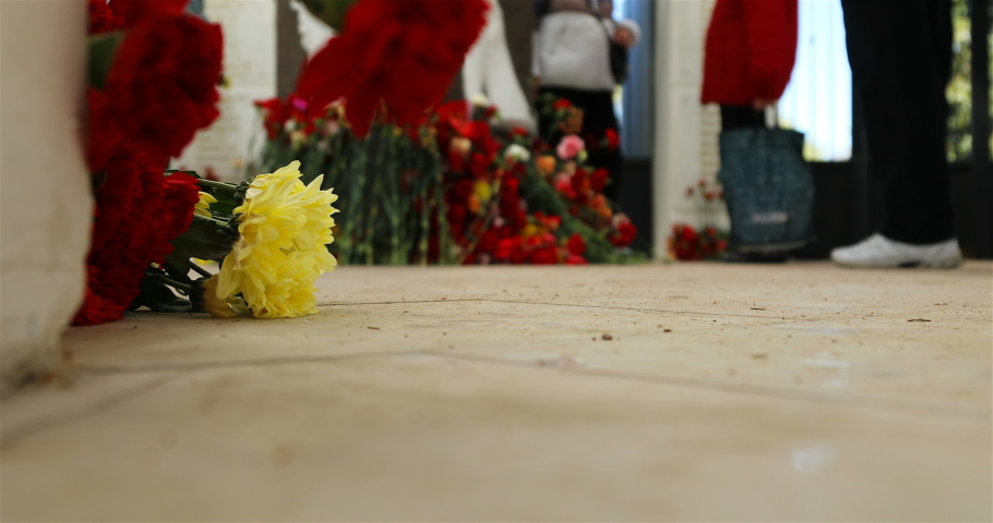 On Victory Day, people lay flowers at the grave of soldiers who died during the war.
