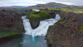 4k drone forward video (Ultra High Definition) of Hjalparfoss Waterfall. Splendid summer scene of Iceland, Europe. Beauty of nature concept background.