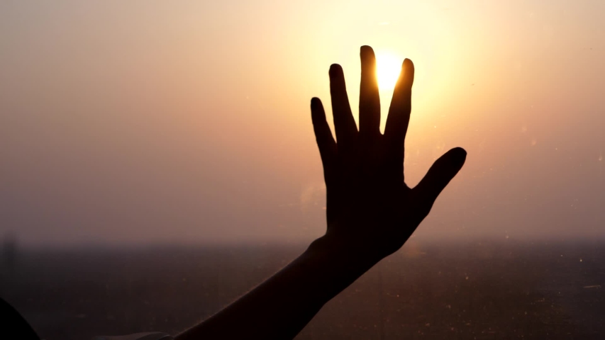 Dreamy passenger put hand on train window, hold against shining sun, bright beam on background, silhouetted palm lie on glass. High speed train ride at evening time | Shutterstock HD Video #1037698694