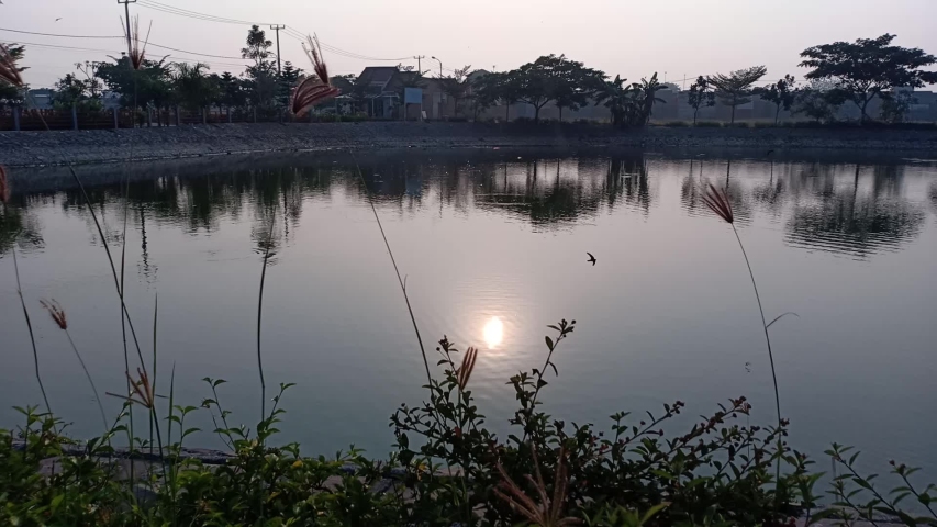 reflected sunlight on the lake water in the morning