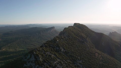 Pic Saint-Loup edge summit in france, Cliff with valleys and a big forest around aerial view