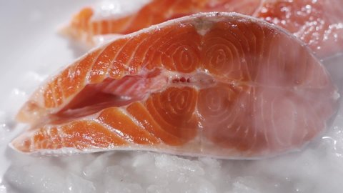 Salmon steaks and salmon fillet. Fresh salmon steaks and fillet are laid out on ice