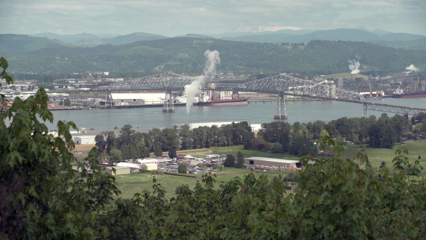 Longview Washington State Columbia River 4K UHD. Longview, Washington State, USA. The Lewis and Clark Bridge crossing the Columbia River between Washington and Oregon. The top of Mount St. Helens in t