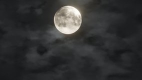 Full glowing yellow moon with clouds being blown by winds during storm at nights. Element of this footage furnished by NASA - Powered by Shutterstock - Get 15% off with code: PIKWIZARD15