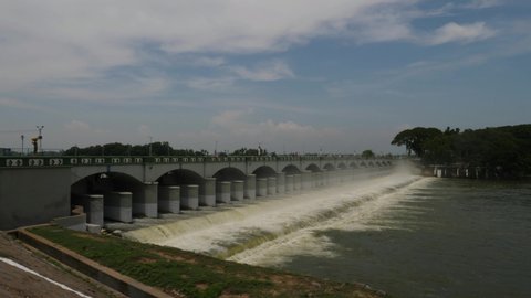Trichy, Tamilnadu / India - September 21 2019: Wide angle panning shot of the overflowing Kallanai Dam on a sunny day