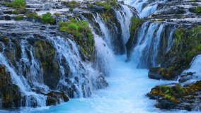 Fantastic sunset on Bruarfoss Waterfall, secluded spot with cascading blue waters. Colorful evening in Iceland, Europe. Beauty of nature concept background. Full HD video (High Definition).