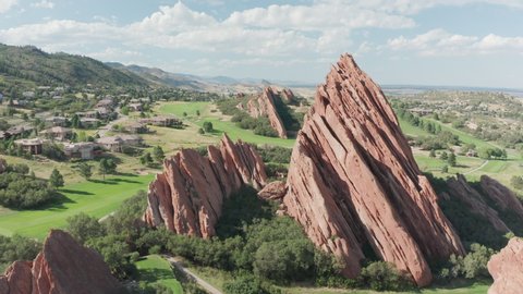 Arrowhead golf course resort in Littleton Colorado with green grass, red rocks, and blue skies