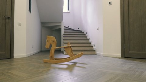 Children's wooden horse stands in the middle of the house