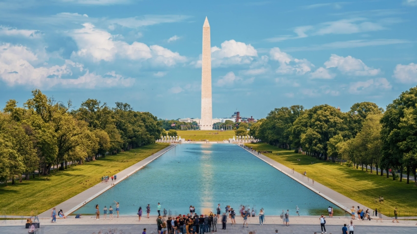 Beautiful Washington Monument on the Reflecting Pool in Washington, DC, USA at dawn. Time lapse view.