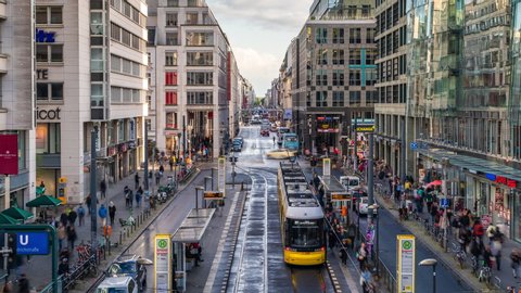 Berlin, Germany - September 21, 2019: Zoom in time lapse view of trams, traffic and pedestrians on Friedrichstrasse street and shopping district in central Berlin by day during fall season.