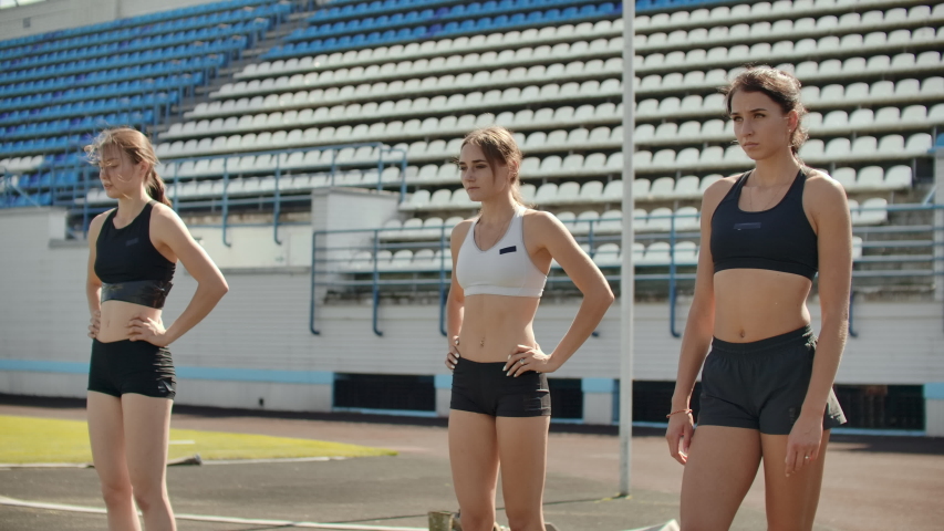 Side view of a group female athlete starting her sprint on a running track. Runner taking off from the starting blocks on running track
