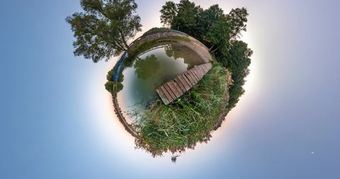 NO VR. Little planet Transformation with curvature of space. Abstract torsion and spinning of full flyby panorama of landscape in forest near lake. falling drone
