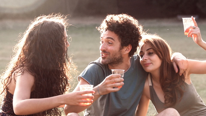 focus on Happiness, joy,freedom- friends doing Happy toast in a park- slow motion