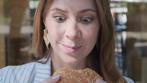 Close up Funny face woman eating vegetarian burger. Pleasure. Healthy eating. Funny emotions slow motion 4k video.