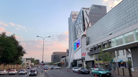 Johannesburg, South Africa, 20th September - 2019: Street view of business district with traffic in foreground.