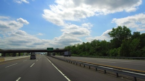 A driver's view of the New Jersey Turnpike passing a highway sign. 