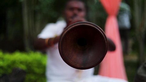  Bangalore, Karnataka / India - July 28 2019: Tight close up of a man playing nadaswaram, a double reed wind instrument famous in South India