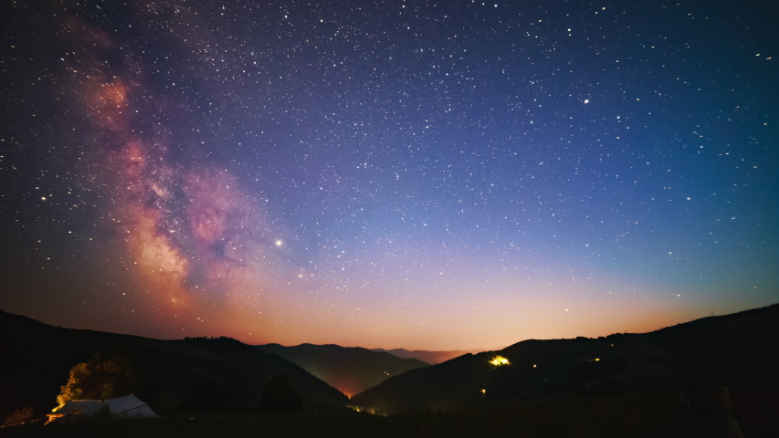 The Milky Way Galaxy moving over the mountains in night sky full of Perseids Royalty-Free Stock Footage #1037806007