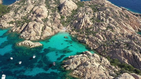 View from above, stunning aerial view of Cala Coticcio also known as Tahiti with boats and yachts floating on a turquoise clear water. La Maddalena Archipelago, Sardinia, Italy.