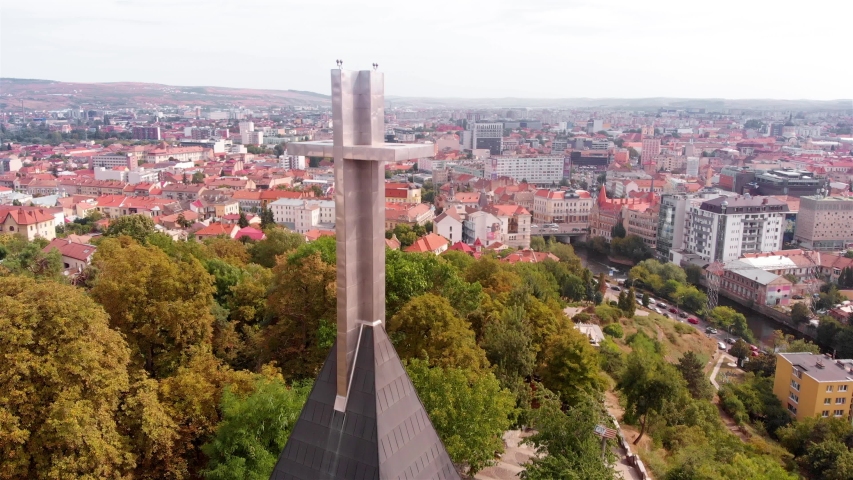 Aerial Footage of large Cross Above European City
Drone view Flying over Large Metalic Cross on top of the highest point in Cluj Napoca, Romania 
