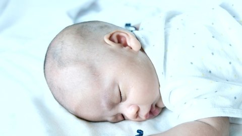 1 month old baby boy lay sleep prone happily.
