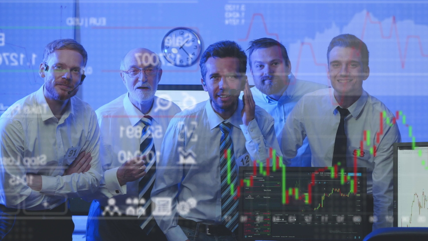 Group of stock market traders attentively looking at screen and monitoring stock growth | Shutterstock HD Video #1037842109