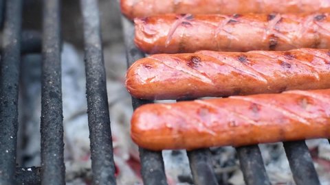 Tasty juicy sausages on the grill. Sausages are grilled BBQ