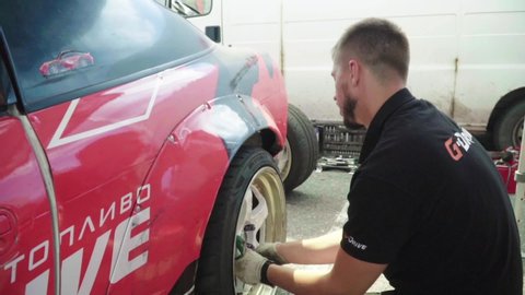 KYIV, UKRAINE – JUNE 29, 2018. Wheel repair of a racing car. Slow motion