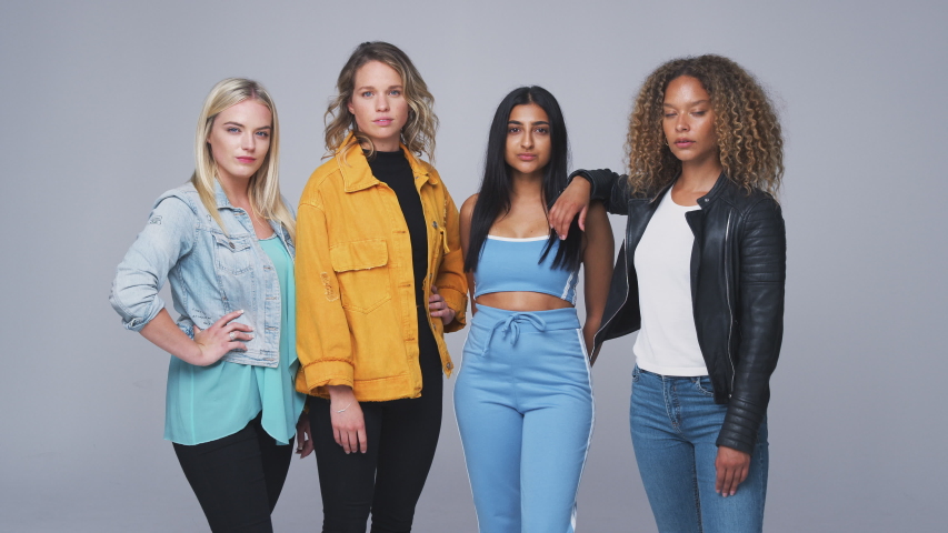 Studio Shot Of Young Independent Multi-Cultural Female Friends Looking Into Camera In Slow Motion
