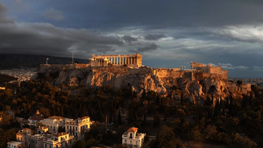 Aerial rising shot of the famous Parthenon temple and Acropolis at sunset. Athens, Greece Royalty-Free Stock Footage #1037890499