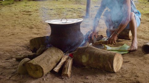 amazonian indigenous chief crushing ayahuasca sticks in ecuador