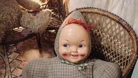 Old creepy baby doll seated on a rocking chair made of wood. 4k - Powered by Shutterstock - Get 15% off with code: PIKWIZARD15