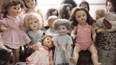 Antique ceramic dolls of different decades. Showcase of ceramic dolls in vintage store.4k