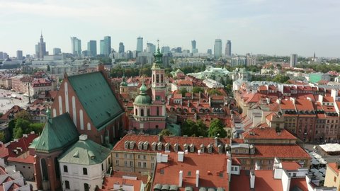 Aerial view of the old city and the royal palace in the historical center of Warsaw, Poland. Drone shot flying over city buildings in the Old Town.