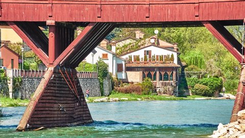 Bridge over Brenta River, called Ponte Vecchio (Old bridge), Ponte di Bassano or Ponte degli Alpini, is covered wooden pontoon bridge by architect Andrea Palladio in 1569 in Bassano del Grappa, Italy.